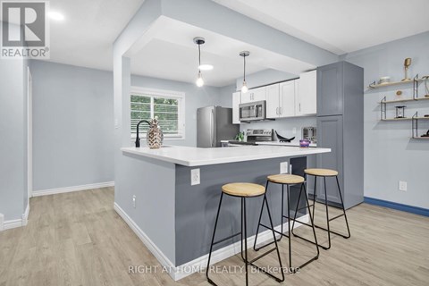 A kitchen with a bar stool and a counter.