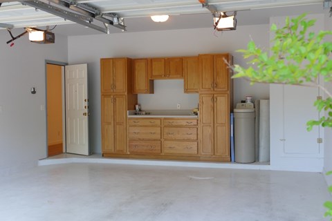 A kitchen with wooden cabinets and a white countertop.