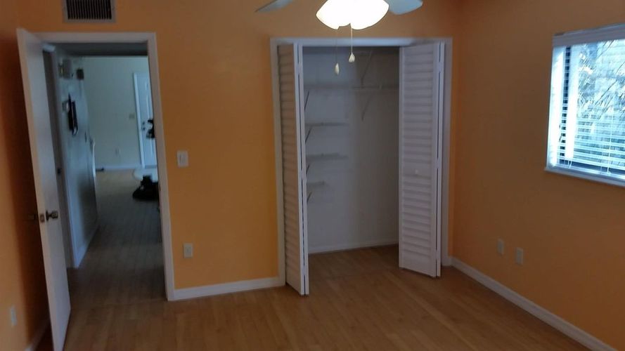 A room with orange walls and a white door.