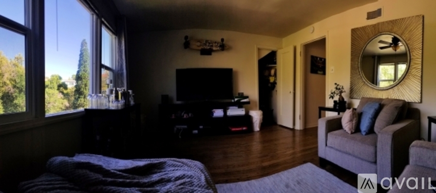 A living room with a grey couch and a television.