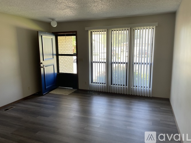 A room with a sliding door and a window with blinds.