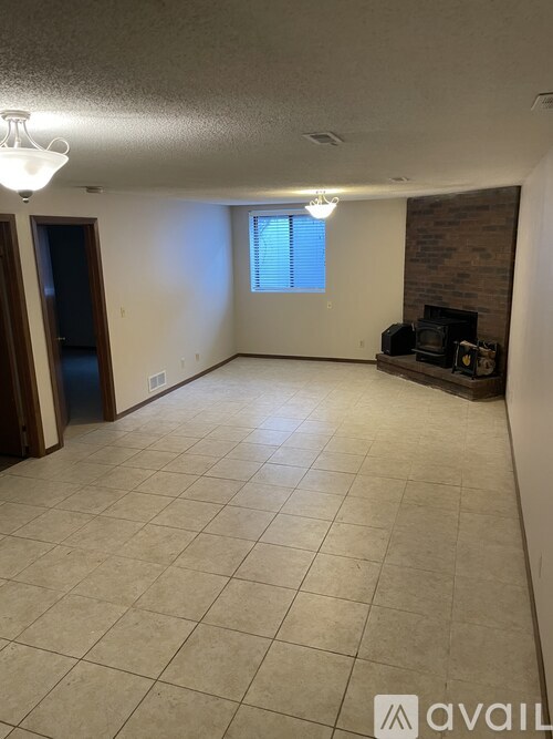 A living room with a fireplace and a flat screen TV.