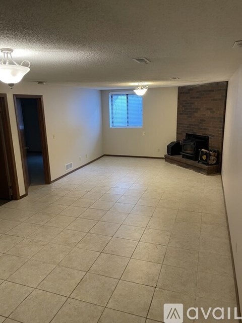 A living room with a fireplace and a flat screen TV.