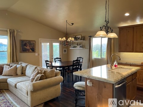 A kitchen with a couch and a table.
