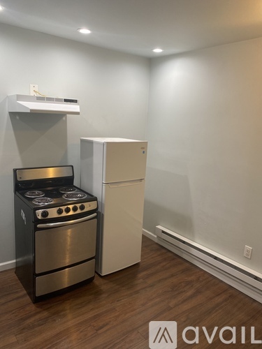 A modern kitchen with a stainless steel stove and a white refrigerator.