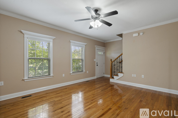 A room with wooden floors and a ceiling fan.