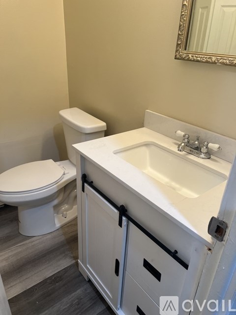 A white toilet sits next to a sink in a bathroom.