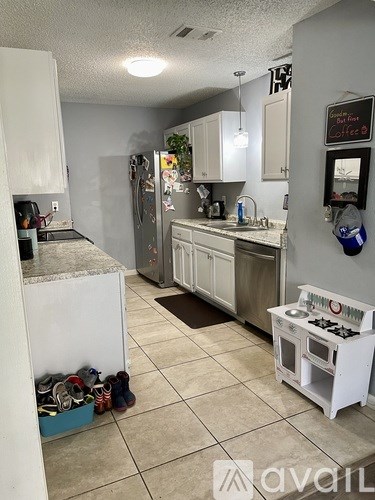 A kitchen with a white fridge and a white stove top oven.