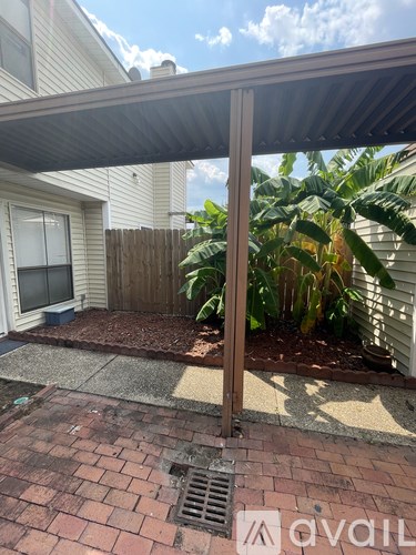 A patio with a metal awning over it.