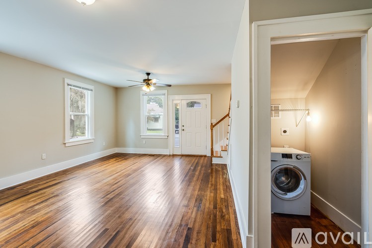 A room with wooden floors and a ceiling fan.