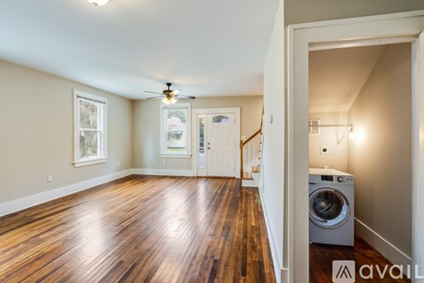 A room with wooden floors and a ceiling fan.