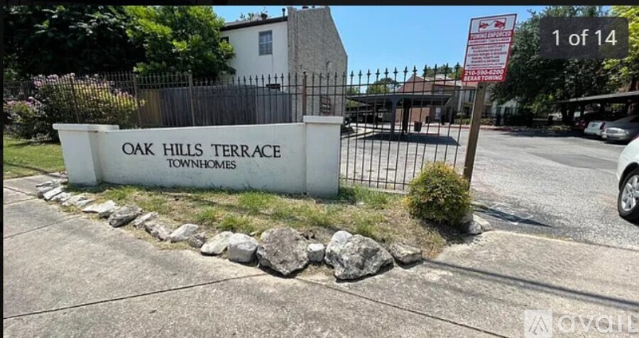 A sign for Oak Hills Terrace is displayed in front of a gated entrance.