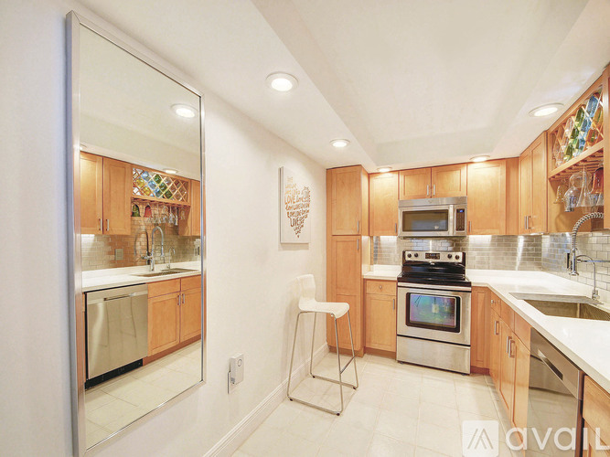 A kitchen with wooden cabinets and a stainless steel oven.