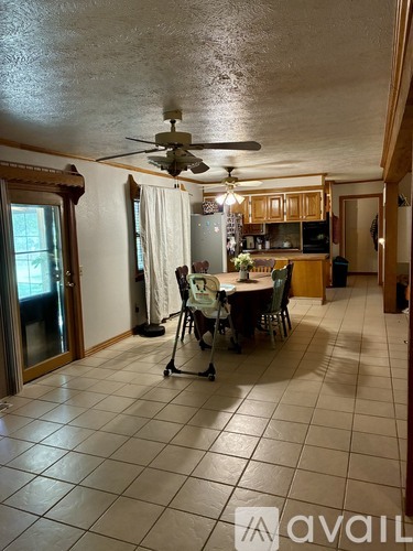 A kitchen with a dining table and chairs in the middle of the room.