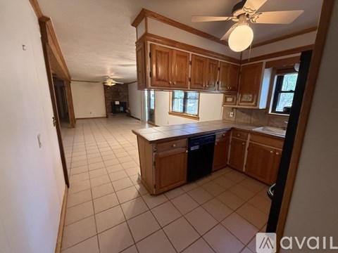 A kitchen with a dining table and chairs in the middle of the room.