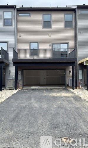 A two-story apartment building with a garage door in front.