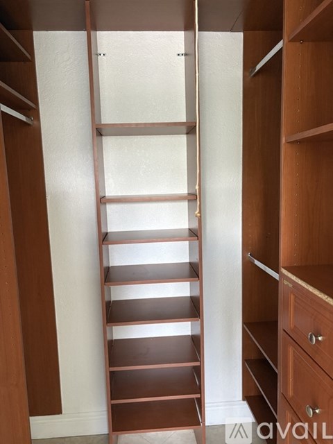 A wooden shelving unit with a ladder.