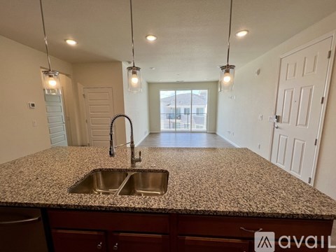 A kitchen with granite countertops and a sink.
