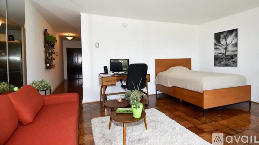 A bedroom with a bed, desk, and chair.