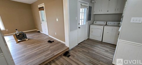A room with a washer and dryer in it.