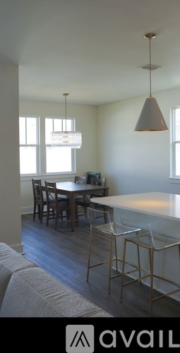 A kitchen with a table and chairs.
