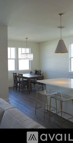 A kitchen with a table and chairs.