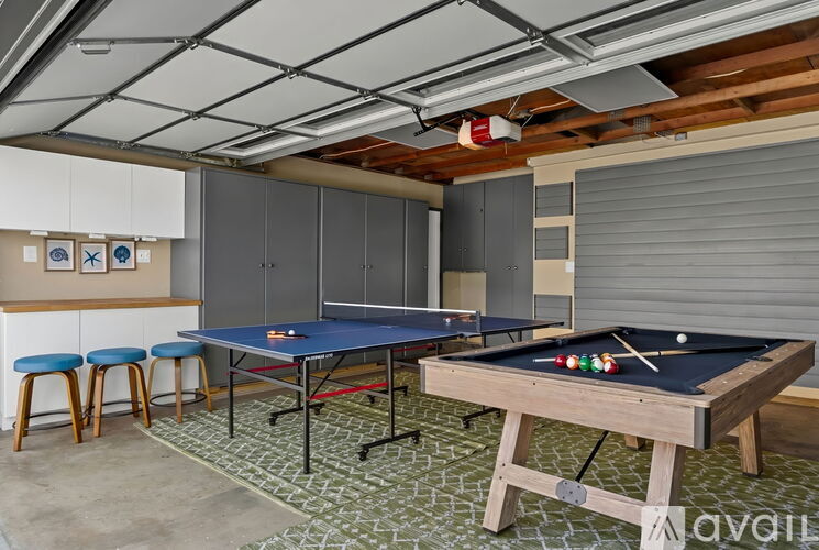 A pool table with a blue cloth and a pool cue in the middle of the table.