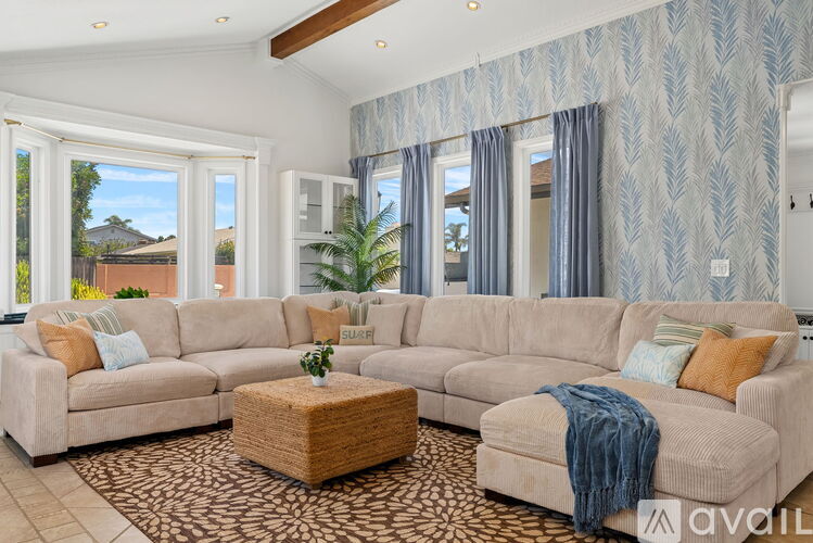 A living room with a large sectional sofa and a coffee table.