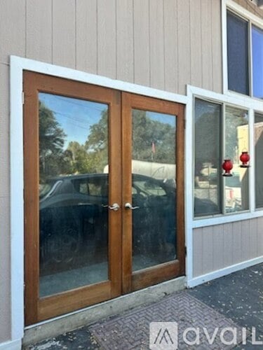 A white door with a glass window and a wooden frame.