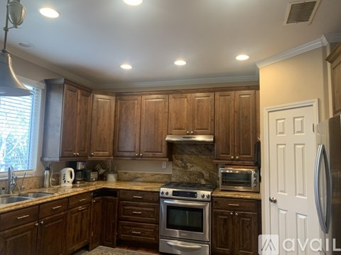 A kitchen with wooden cabinets and stainless steel appliances.