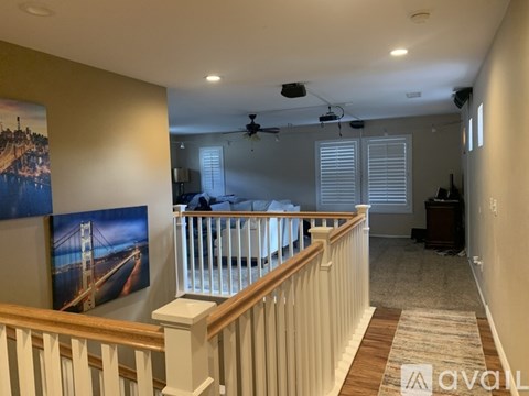 A living room with a bridge picture on the wall.