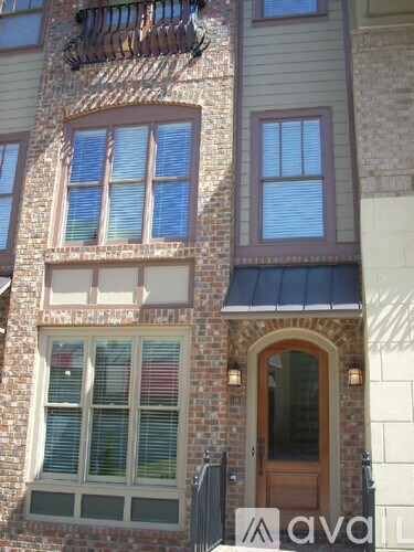 A building with a balcony and a door.