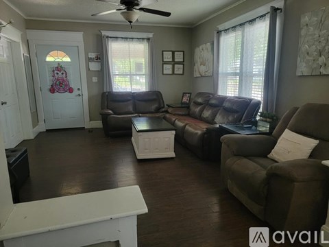 A living room with a ceiling fan and a couch.