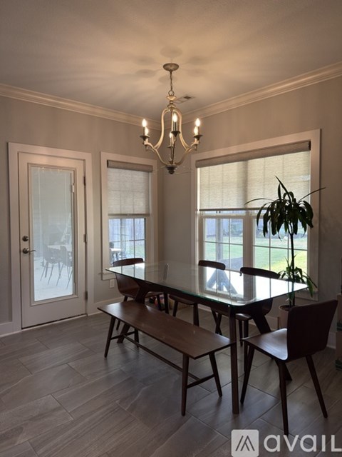 A dining room with a table and chairs.