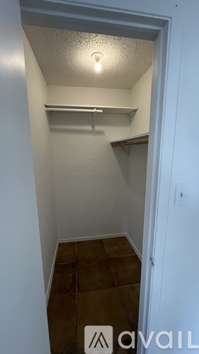 A small, empty room with a light on the ceiling.