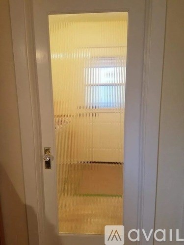 A white door with a glass window in the middle.
