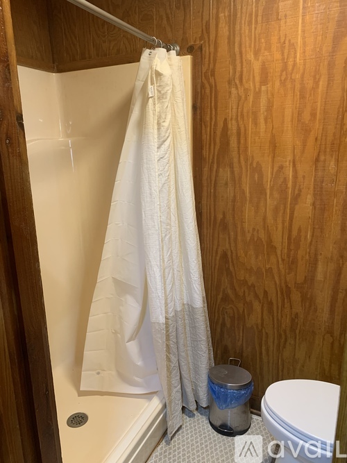 A white towel is hanging on a towel rack in a bathroom.