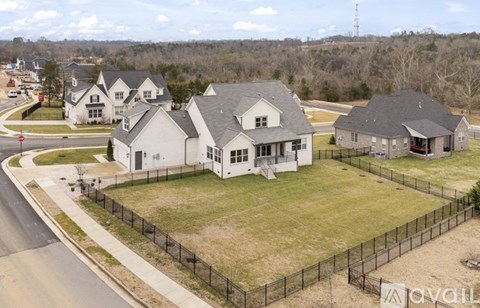 A row of houses with a fence in front of them.