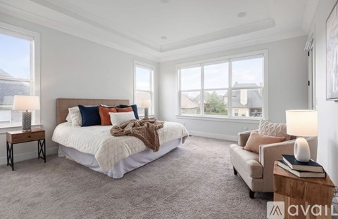 A bedroom with a large bed and a couch.