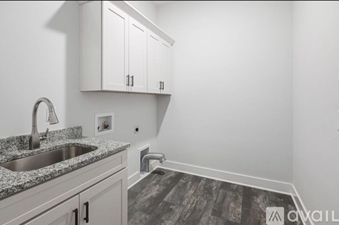 A kitchen with a sink and cabinets.