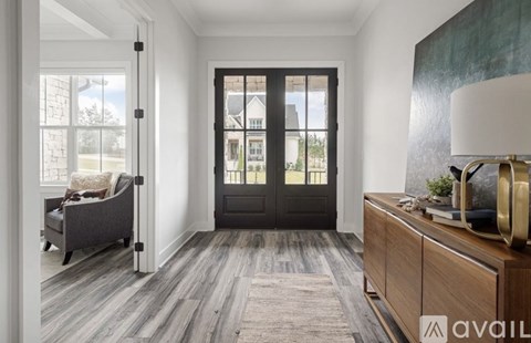 A modern living room with a grey sofa and a wooden cabinet.