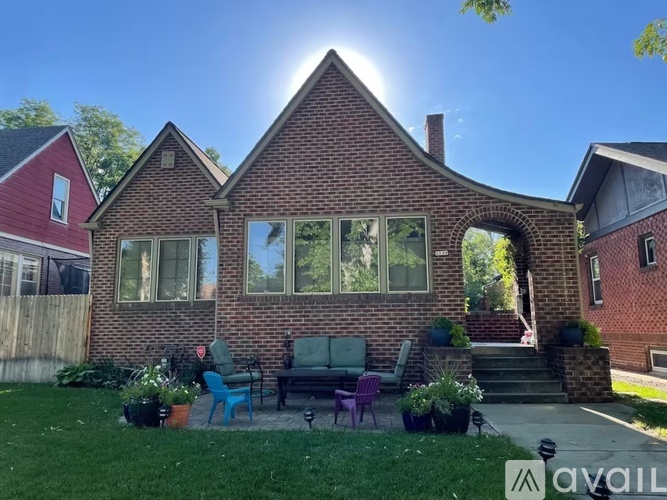 A house with a red brick exterior and a large window.