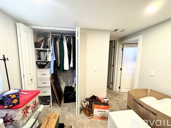 A room with a white closet and a box of Spalding on the floor.