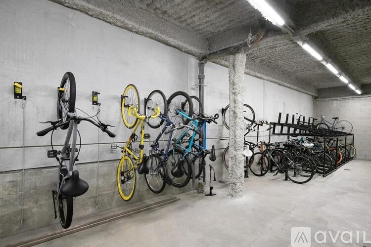 A bike rack with bicycles of various colors and types.