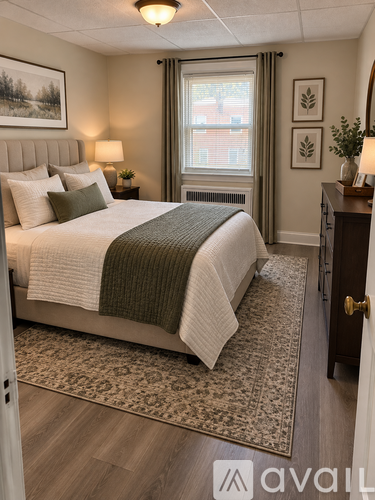 A bedroom with a large bed and a window with a view of a building outside.
