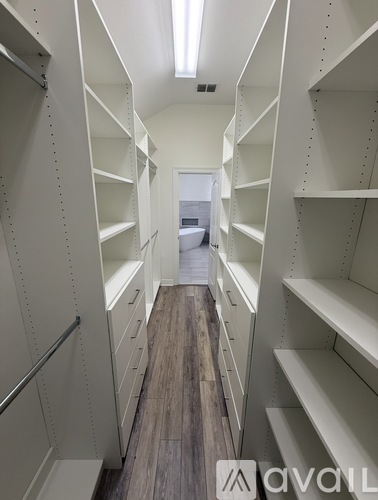 A long hallway with shelves on both sides.