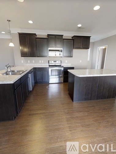 A kitchen with dark wood cabinets and a white countertop.