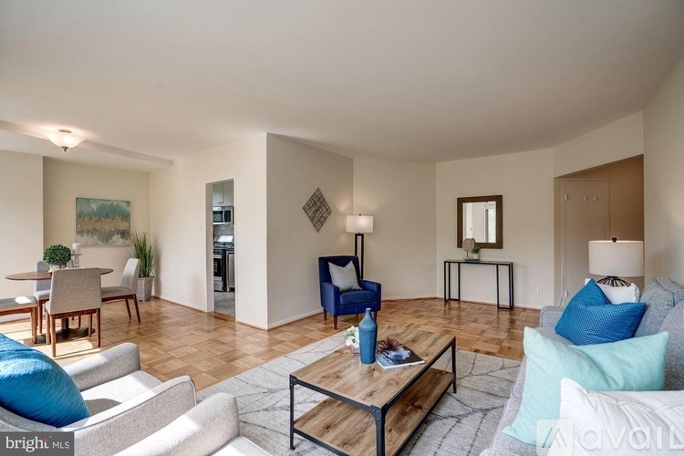 A living room with a blue couch and a wooden coffee table.