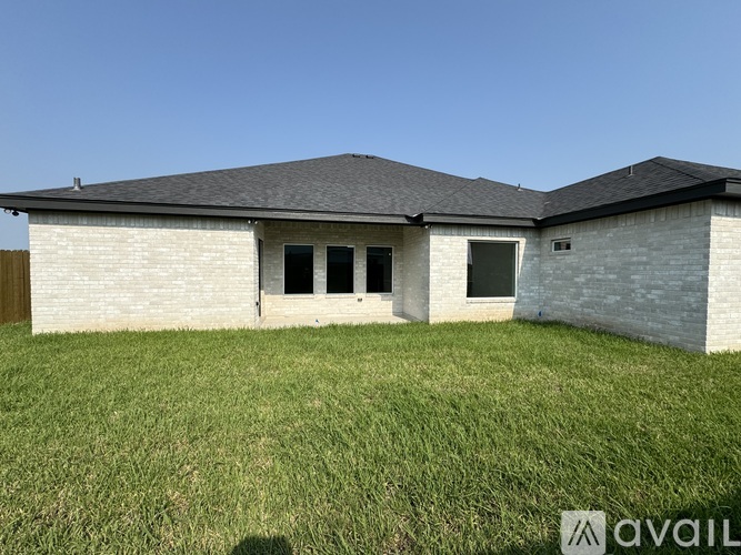 A house with a grassy yard in front.