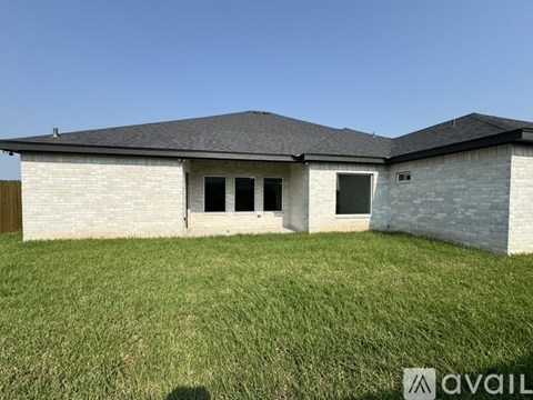A house with a grassy yard in front.